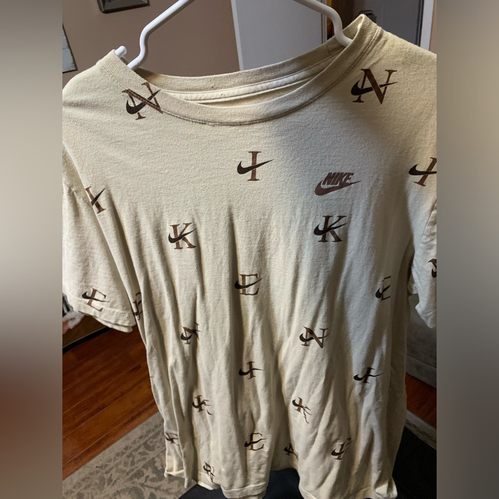 This is a large Nike cream and brown shirt